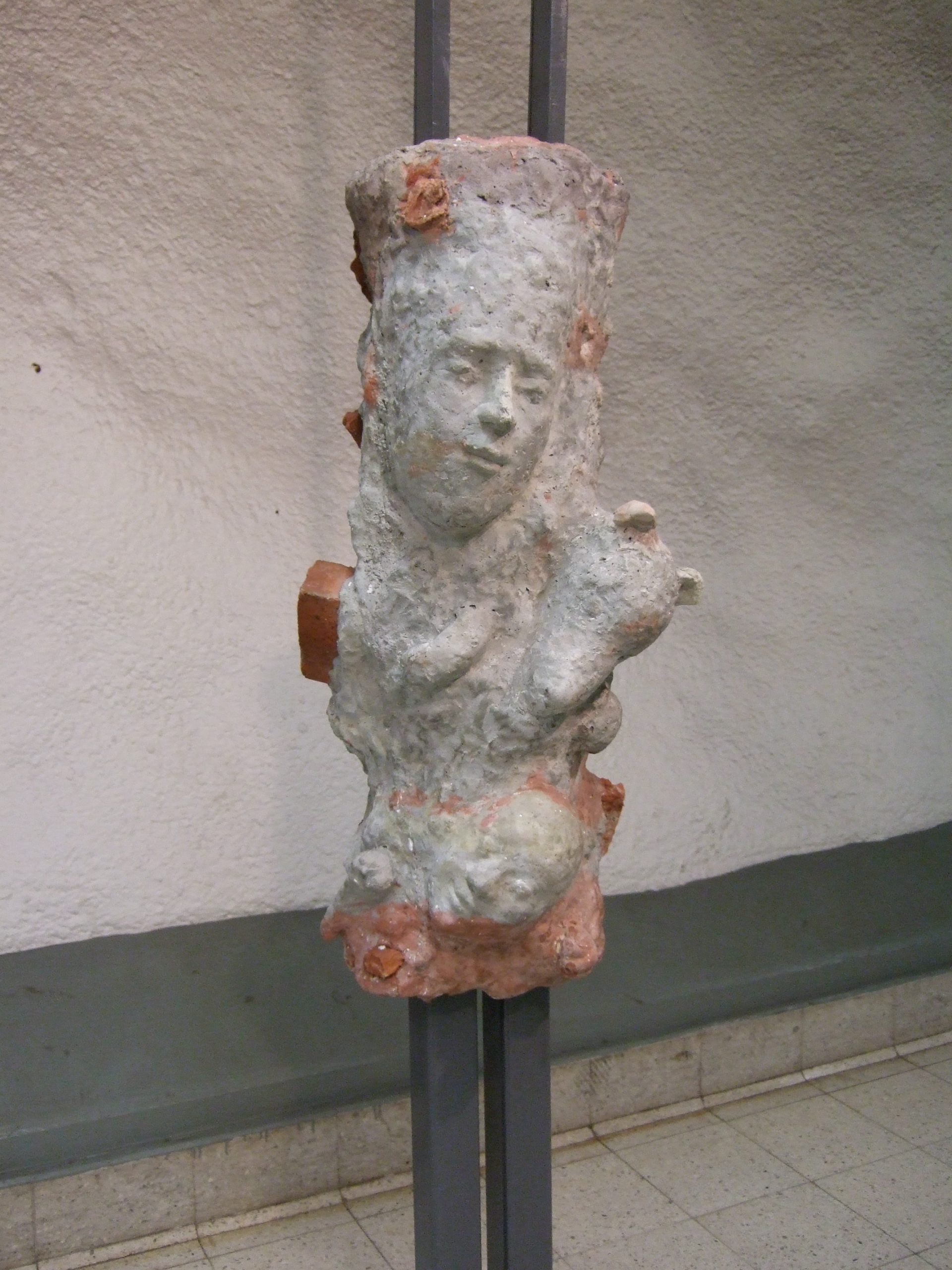 Public artwork – concrete sculpture installation Faces In The Metro, Helsinki Central Railway Metro station, 2007 – front view of a large sculpted face.