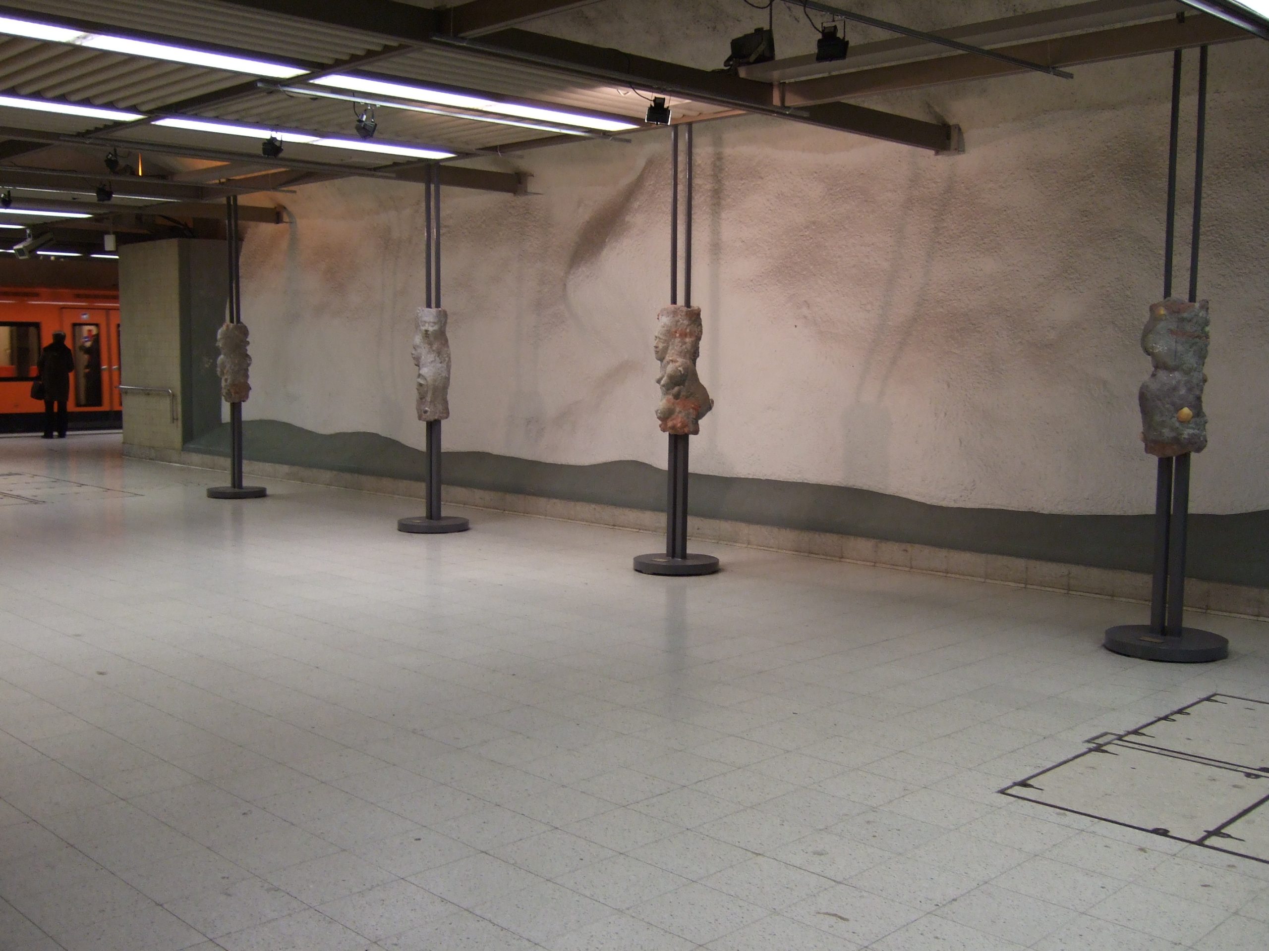Public artwork Faces In The Metro concrete sculpture installation, wide view of the sculpture exhibition at Helsinki Central Railway Metro station, 2007.