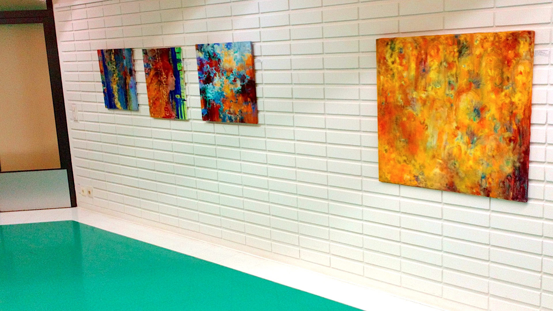 Encounter - Exhibition by Sanna Karlsson-Sutisna - Four colorful abstract paintings displayed on a white-tiled hospital corridor wall. - Jorvi hospital 2019.