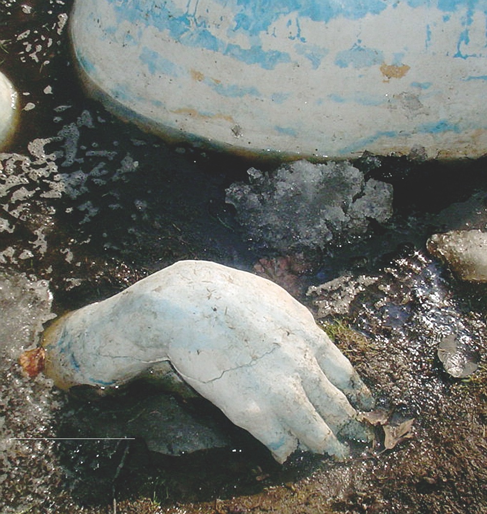 Public Artwork - Flower of Life - A sculpted hand emerging from the ground beside egg-shaped forms and melting snow. - Art park, Pikku-Huopalahti, Helsinki, 2005.