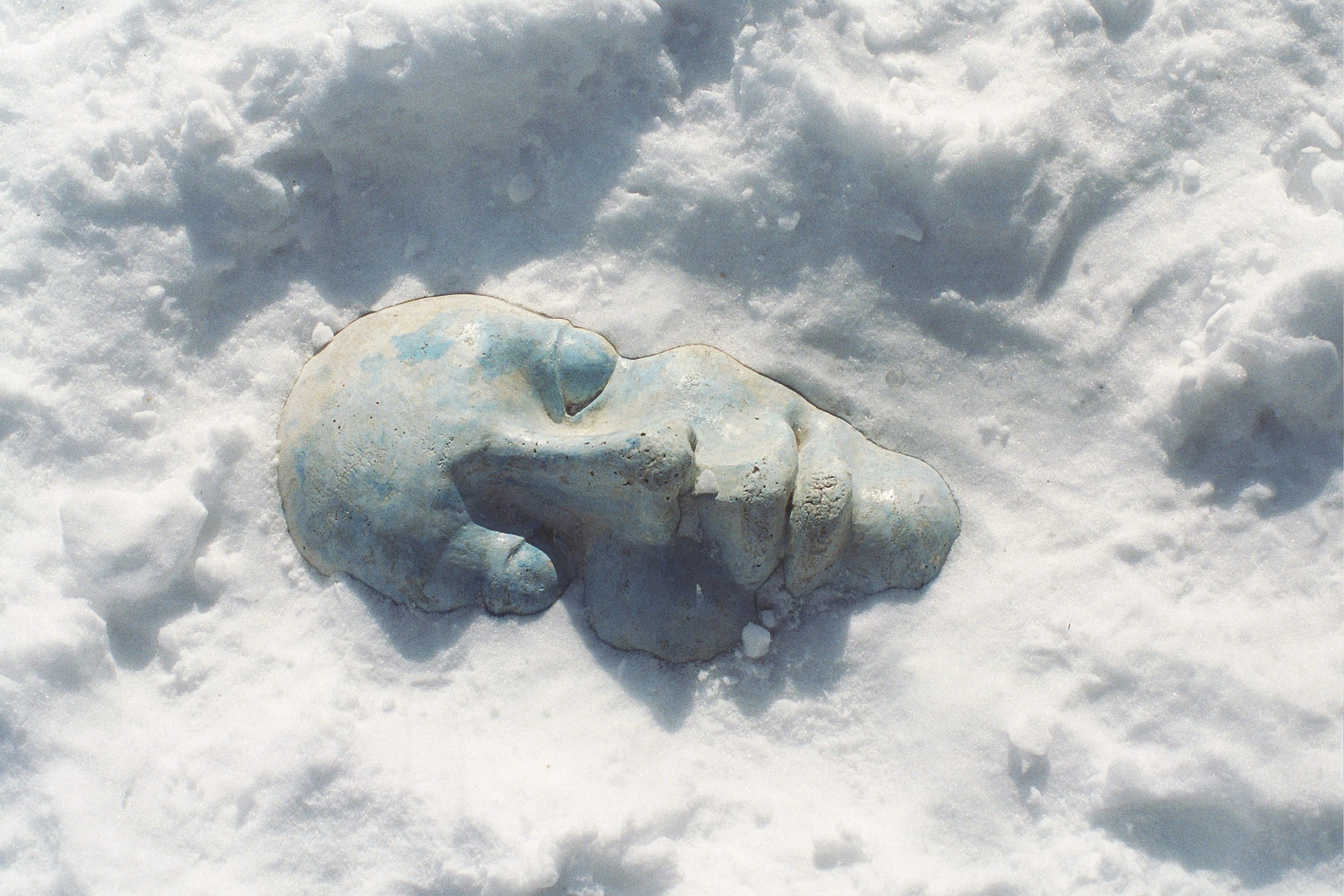 Public Artwork - Flower of Life - A small abstract sculpture resembling a curled sleeping figure partially covered by snow. - Art park, Pikku-Huopalahti, Helsinki, 2005.