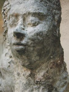 Public artwork Faces In The Metro concrete sculpture installation, frontal close-up of a concrete human face at Helsinki Central Railway Metro station, 2007.