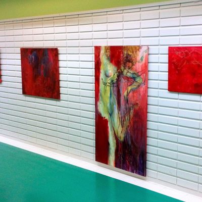 Encounter - Exhibition by Sanna Karlsson-Sutisna - Five abstract paintings in red and blue tones displayed on a white-tiled hospital corridor wall. - Jorvi hospital 2019.