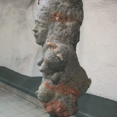 Public artwork Faces In The Metro concrete sculpture installation, side view of a freestanding concrete face sculpture at Helsinki Central Railway Metro station, 2007.