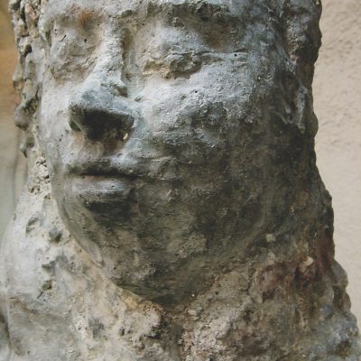 Public artwork Faces In The Metro concrete sculpture installation, frontal close-up of a concrete human face at Helsinki Central Railway Metro station, 2007.